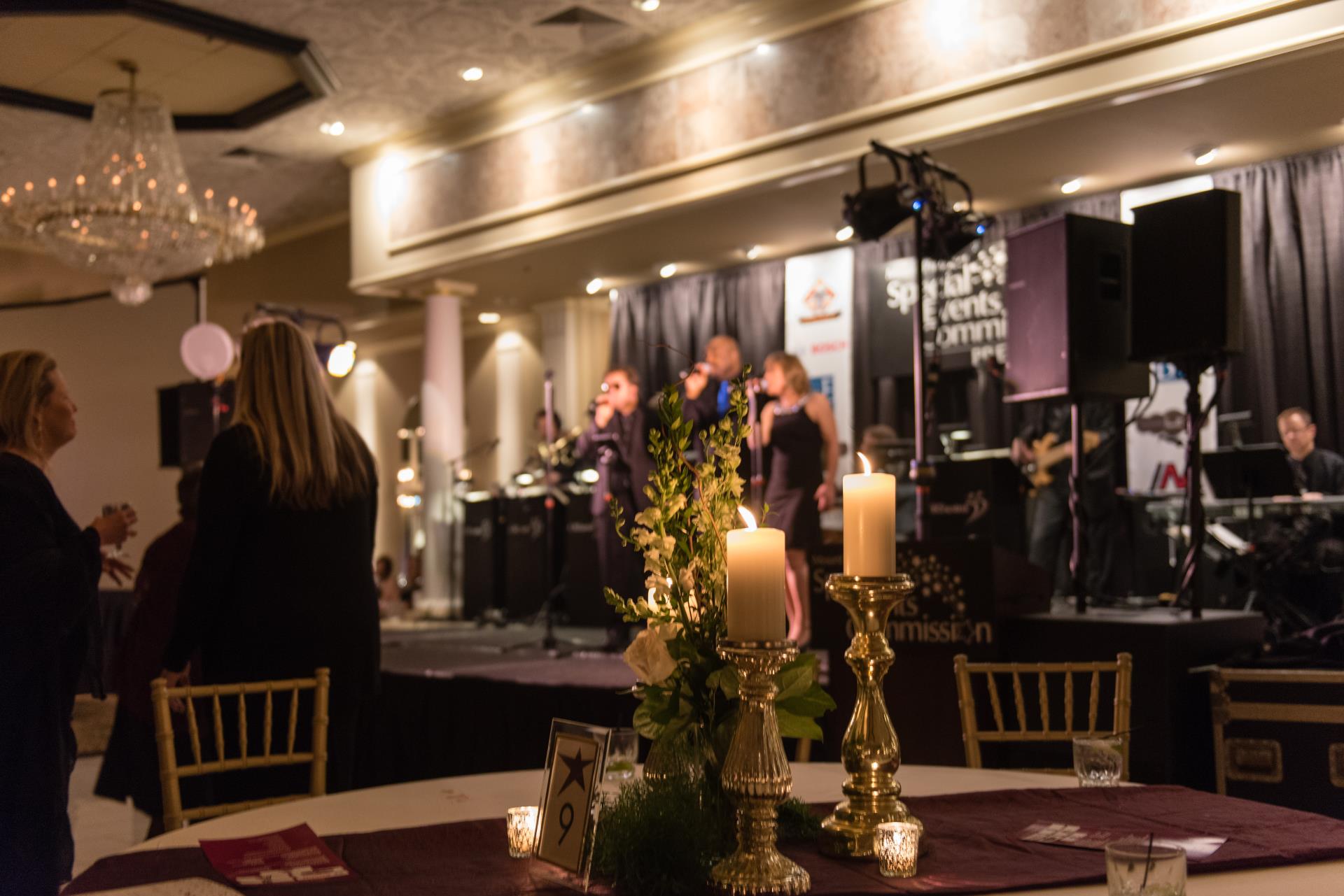 A banquet room featuring elegantly arranged tables and chairs